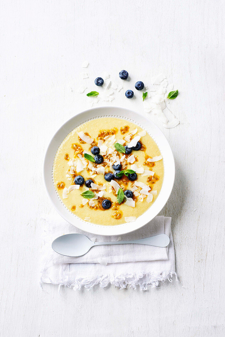 Tropical smoothie bowl with mango, pineapple and coconut yogurt