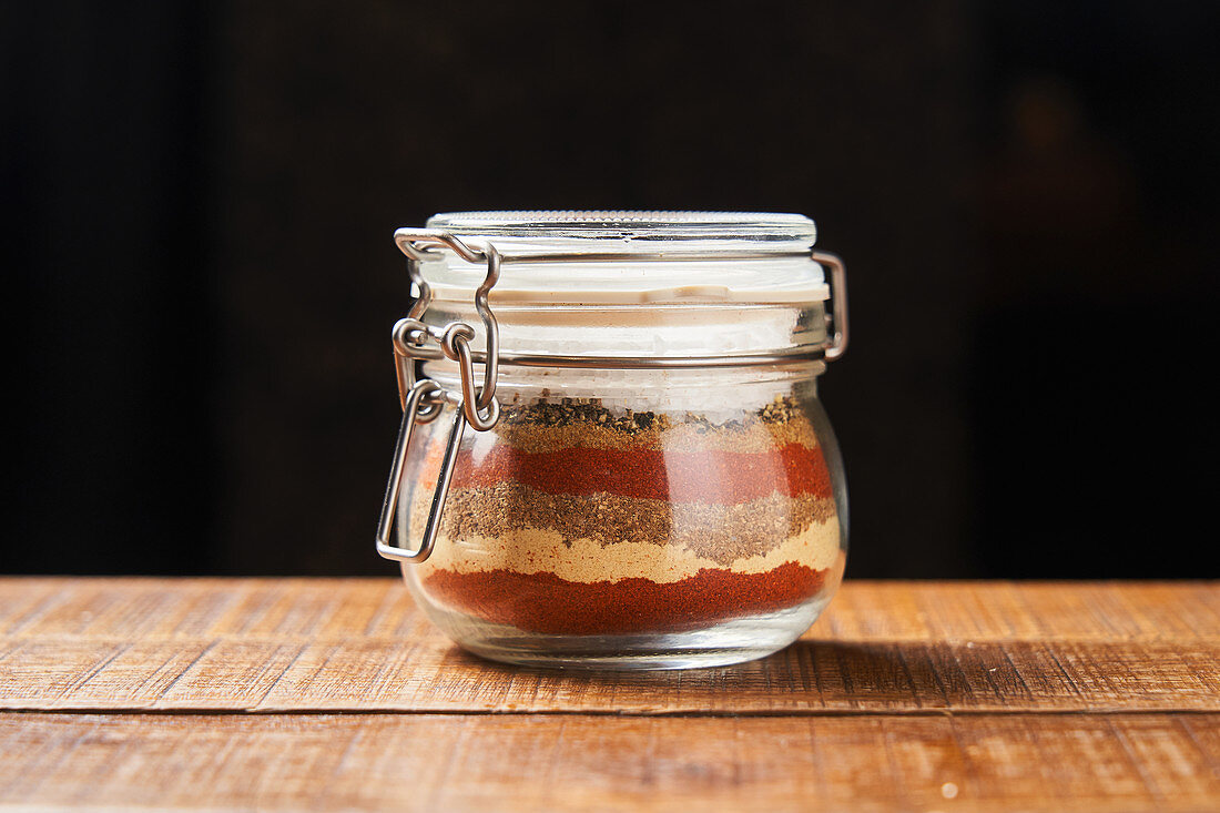 Layers of colorful spices in jar