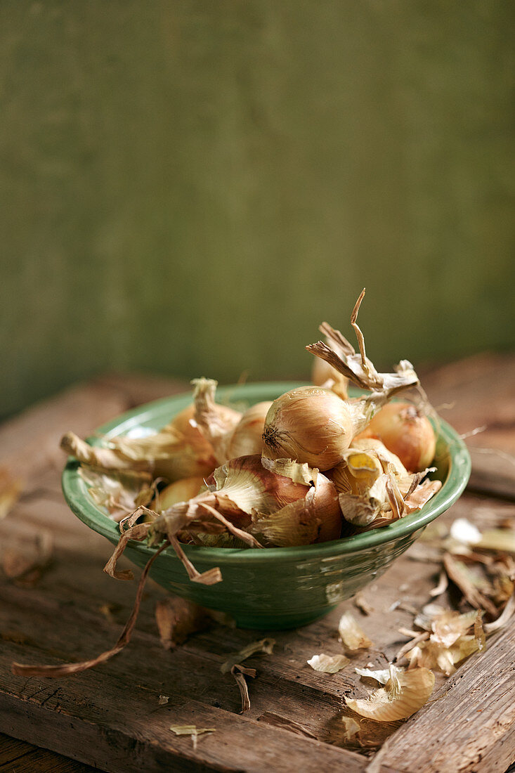 Onions in a green ceramic bowl