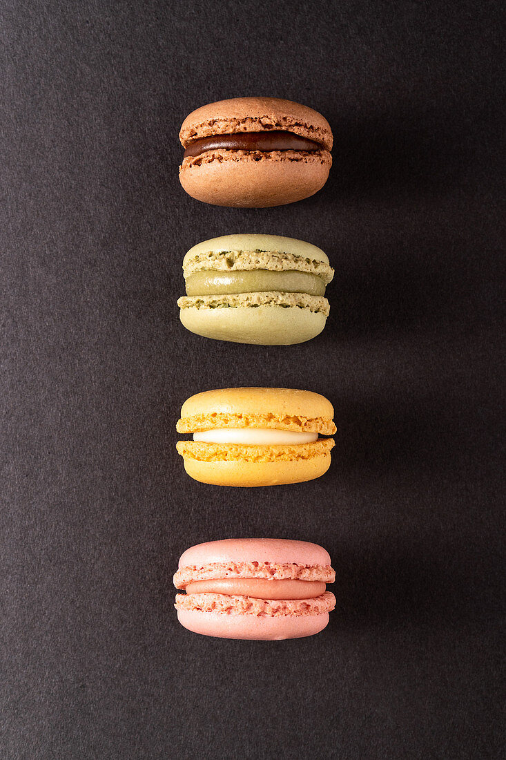 Colorful macaroons displayed on black background