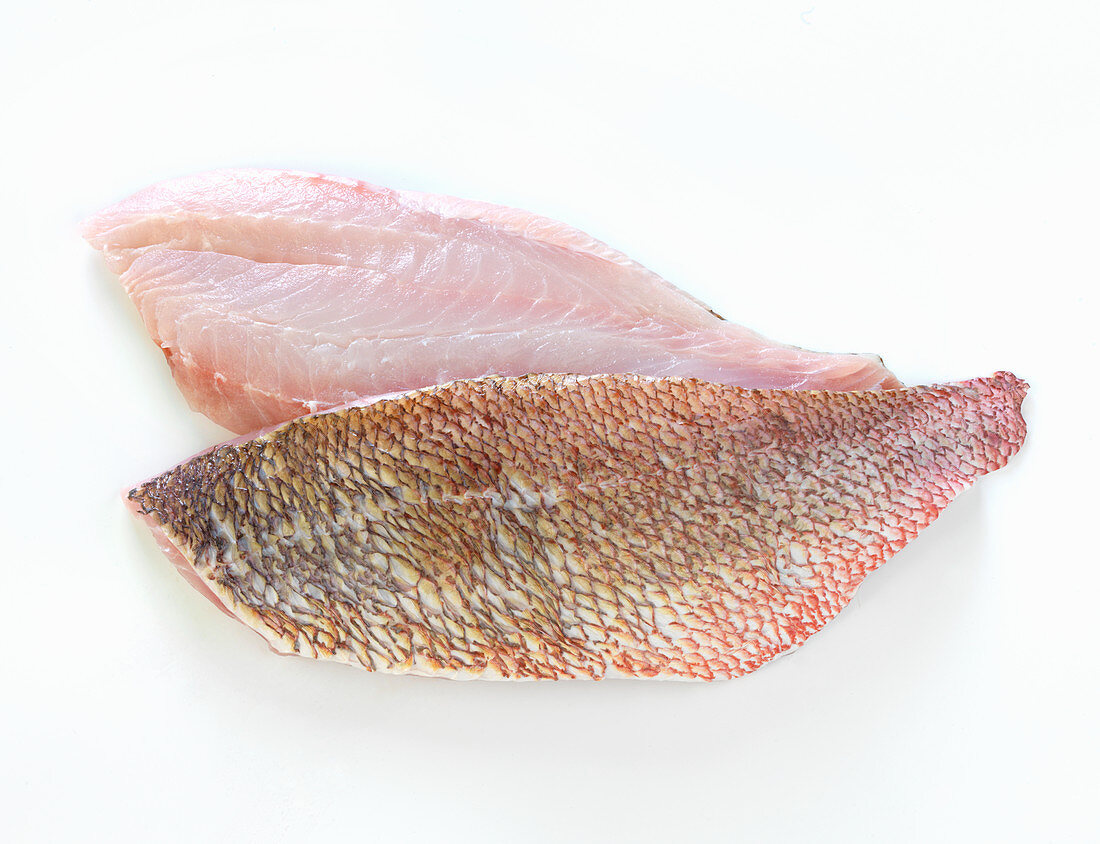 Two raw red mullet fillets on a white background