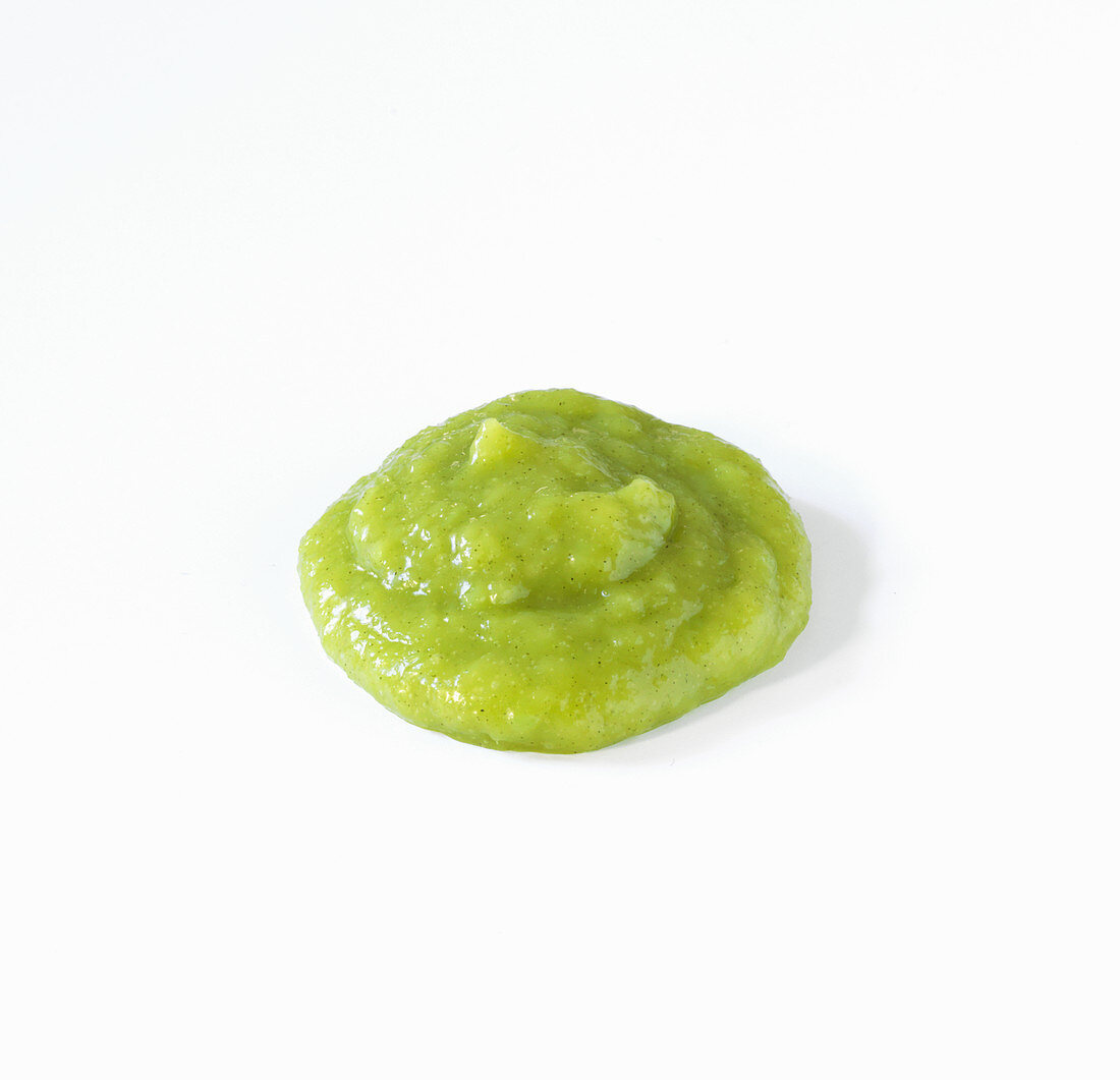A dollop of wasabi sauce on a white background