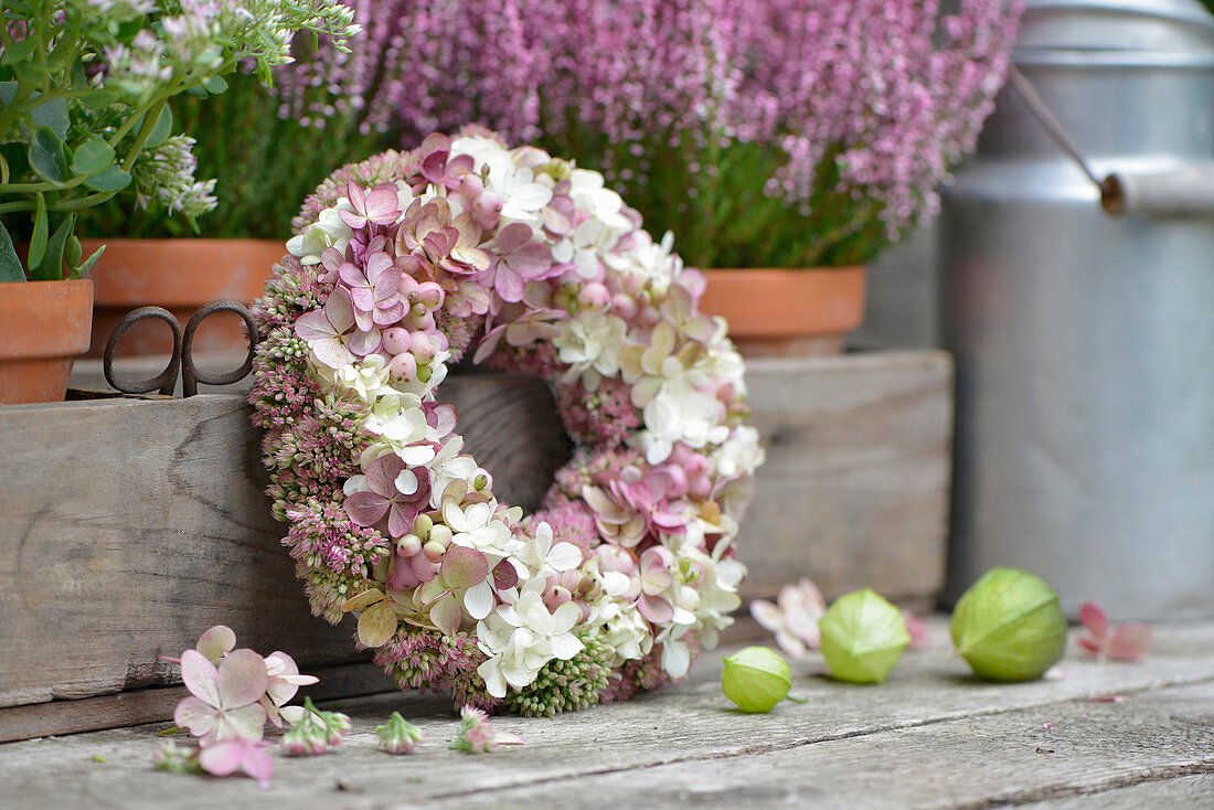 Autumn wreath of hydrangea flowers, sedum, and snowberries