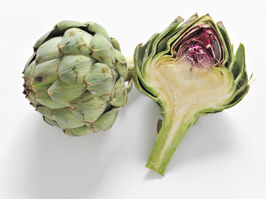 Artichoke, whole and halved on a white background