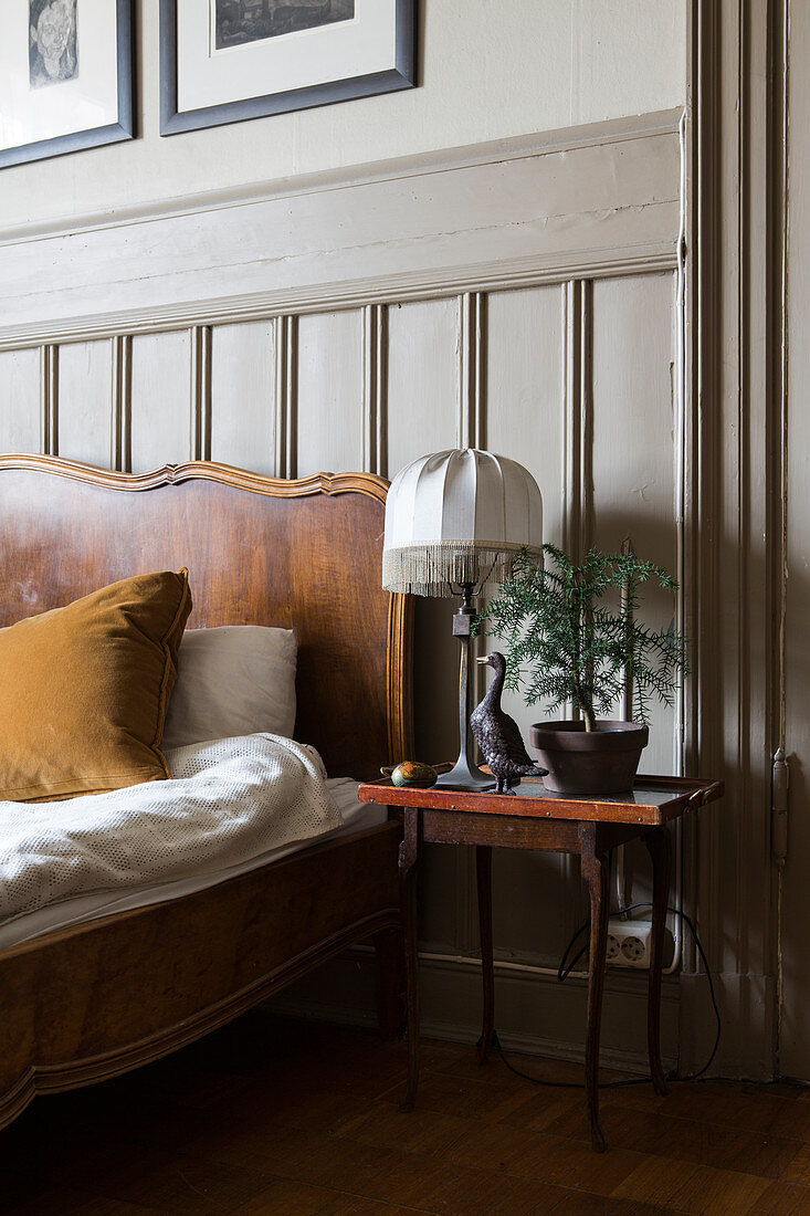 Bedside table in bedroom with classic wainscoting