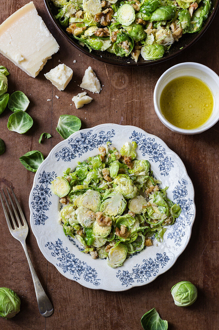 Shredded brussel sprout salad with walnuts, parmesan and mustard dressing, parmesan, brussel leaves