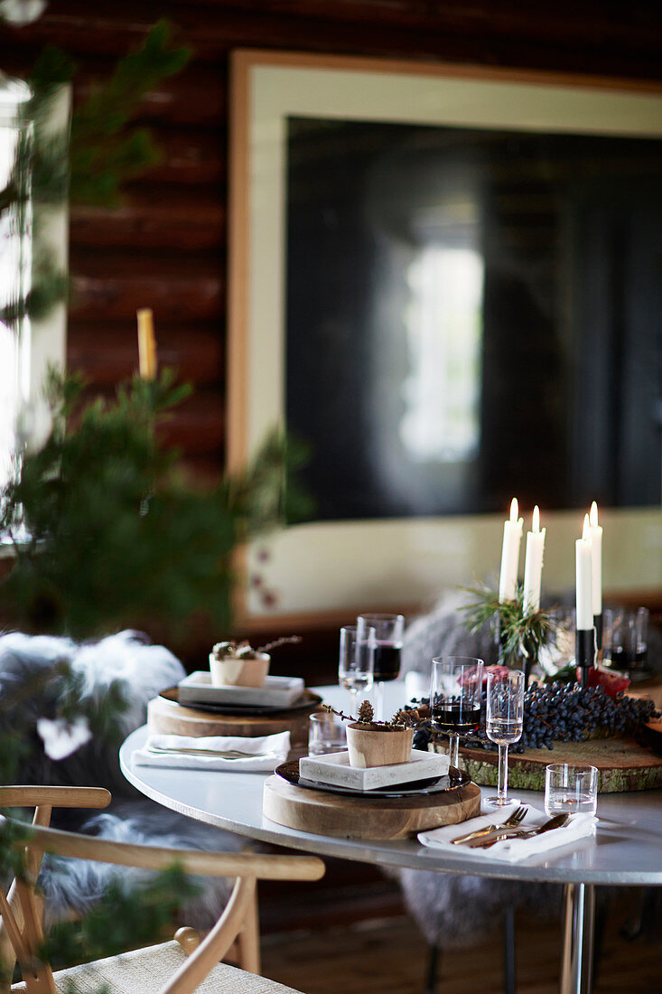 Candles on table festively set for Christmas