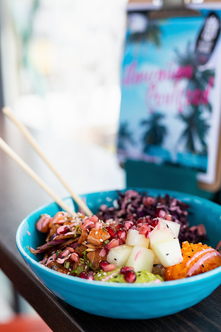 Poké bowl with salmon, mashed sweet potatoes and pomegranate seeds