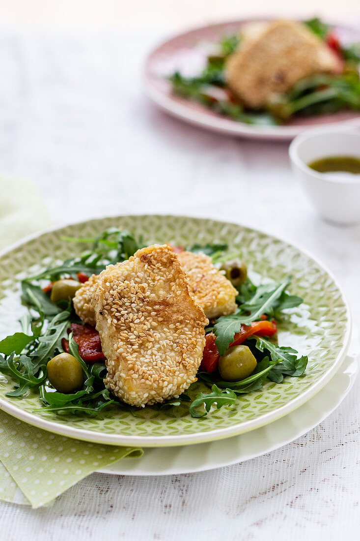 Halloumi grilled in sesame seeds on rocket, grilled red pepper and green olives, dressing white vinegar