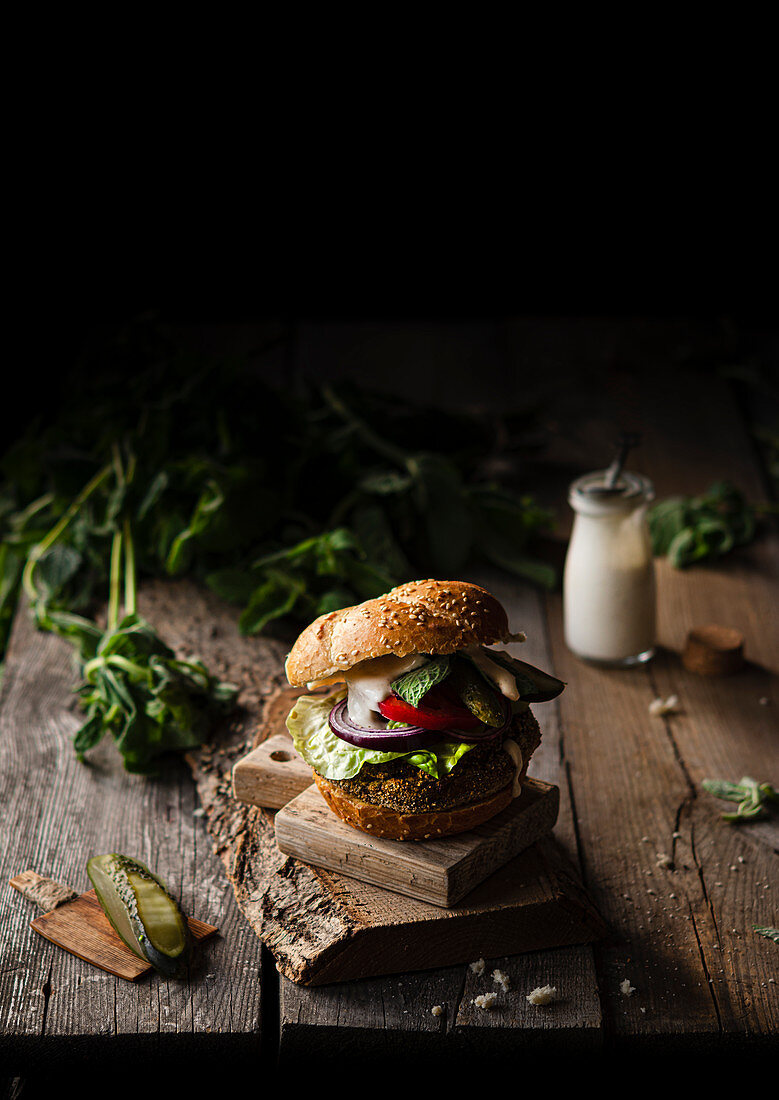 Vegan broccoli burger with vegetables, fresh herbs and vegan mayonnaise