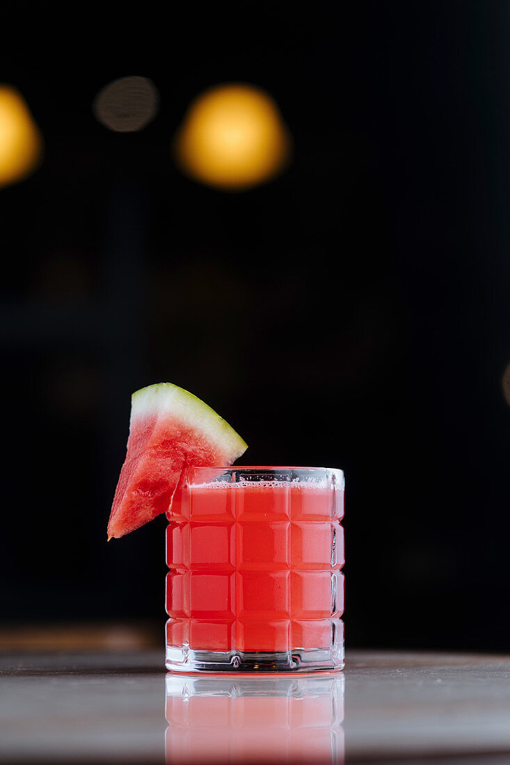 Healthy watermelon smoothie in glass cup decorated with piece of fruit