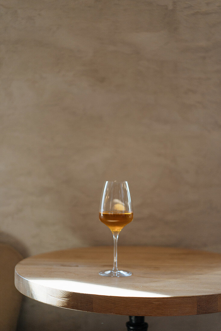 Glass of alcohol beverage on table on restaurant