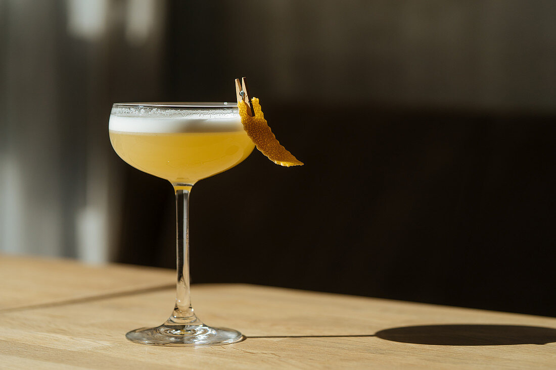 Fresh cocktail in glass festively decorated with clothespin