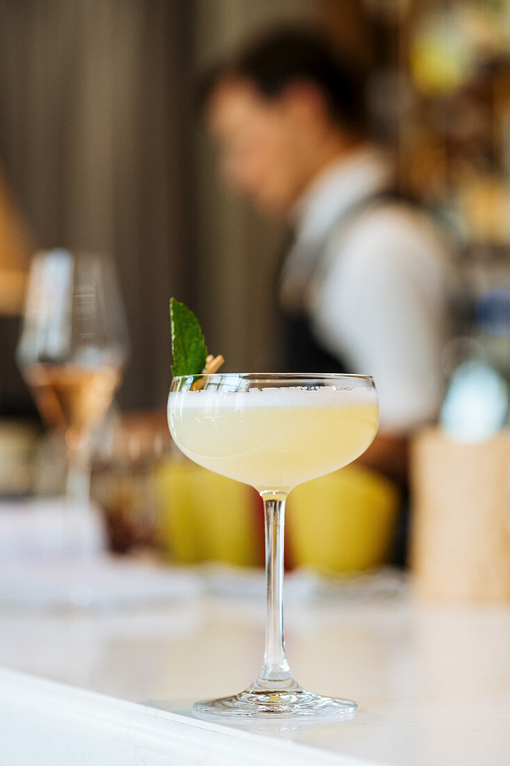 Fresh appetizing cocktail in glass festively decorated with clothespin