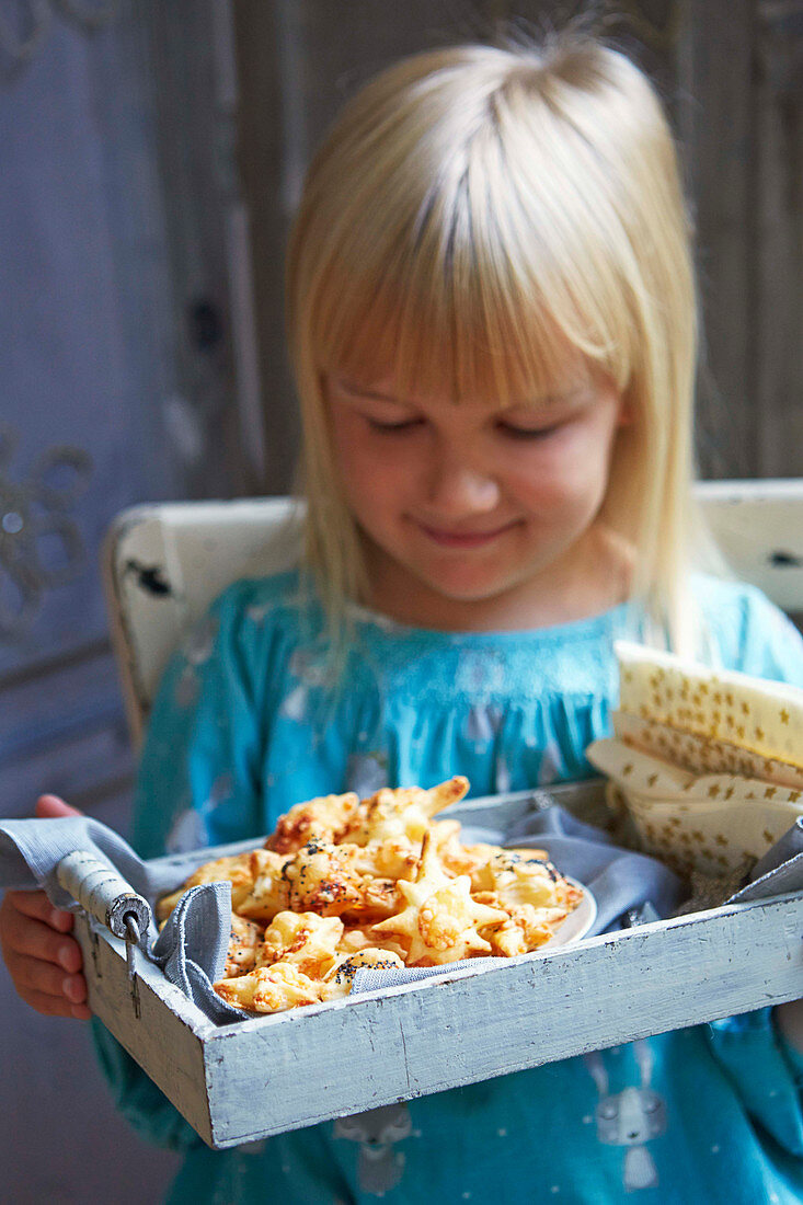 Girl holding plate with cheese stars