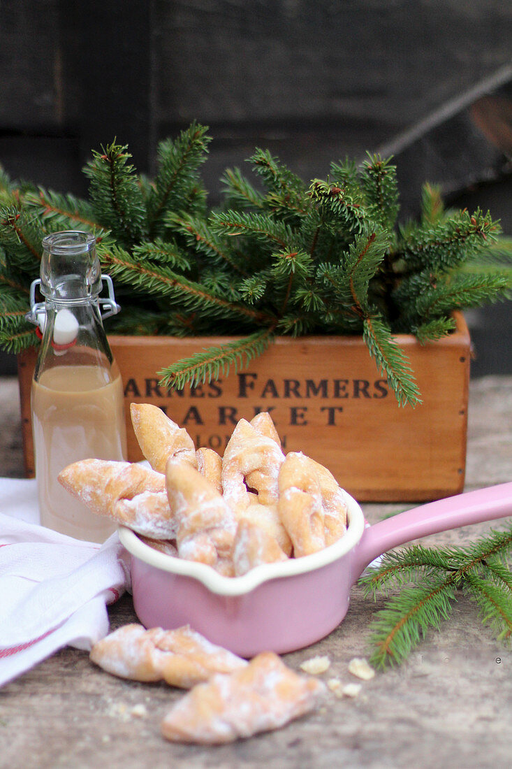 Yeast cakes with icing sugar in a saucepan