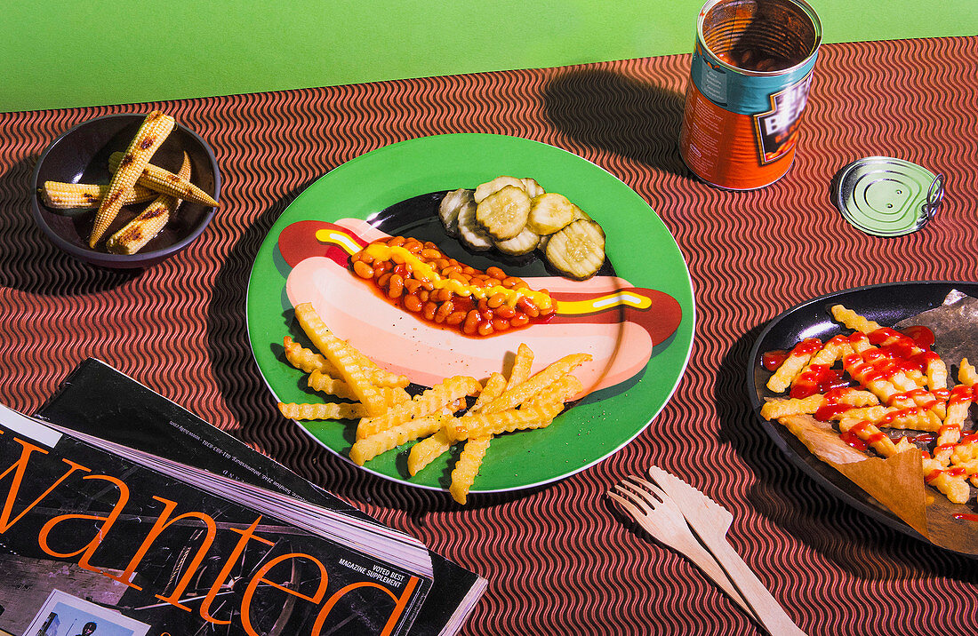 French fries, baked beans and pickles on a plate with a hot dog motif