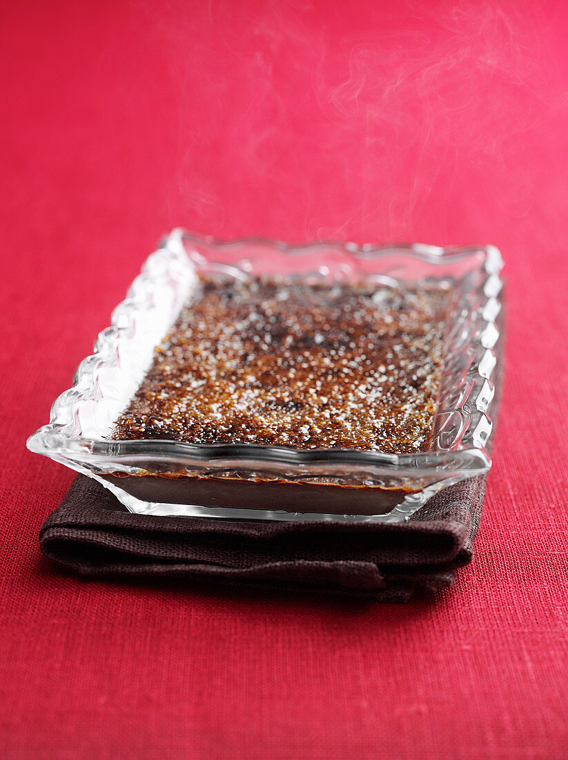 Chocolate creme brulee in a glass bowl