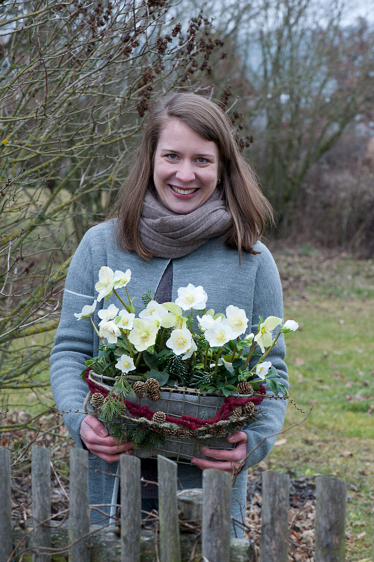 Woman with Christmas Roses in Basket Jardiniere