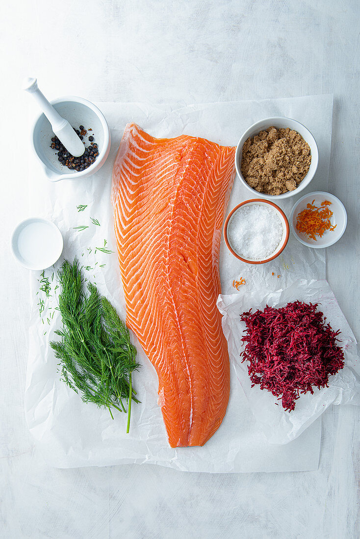 Fillet of salmon and ingredients for beetroot, juniper and gin cured salmon (gravlax)