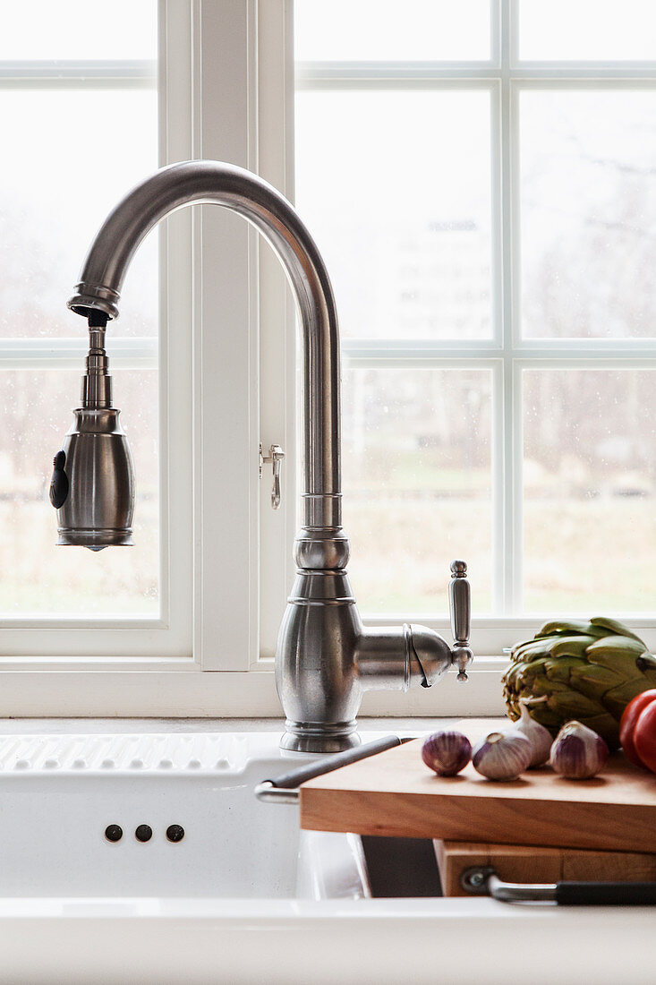 A vintage-style kitchen tap with an extendable hose