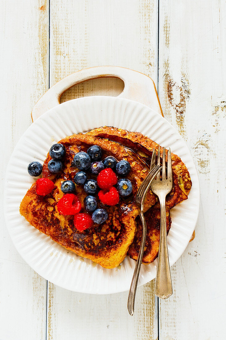 French toasts with berries and maple syrup
