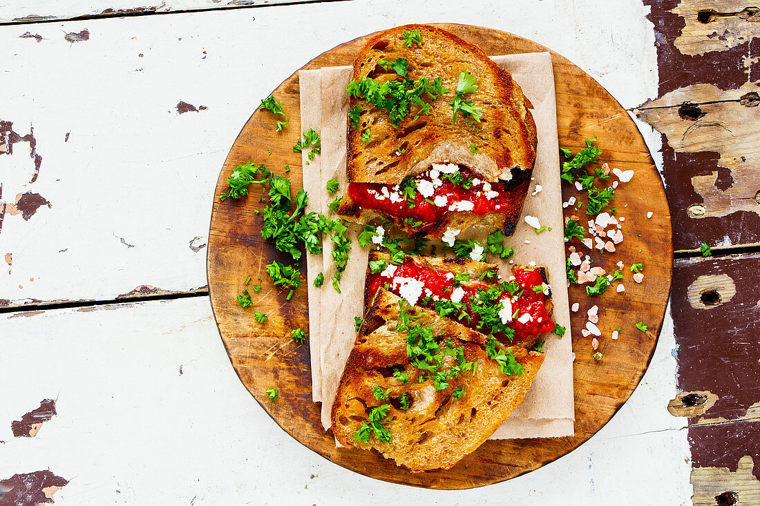 Vegetable spread, feta and fresh herbs on grilled bread