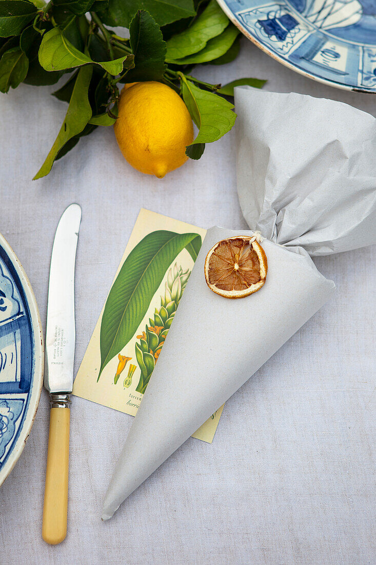 Paper bag with a dried lemon slice tag as table decoration