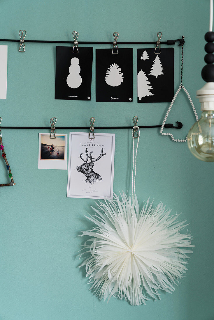 Handmade Christmas decorations in black and white on duck-egg-blue wall