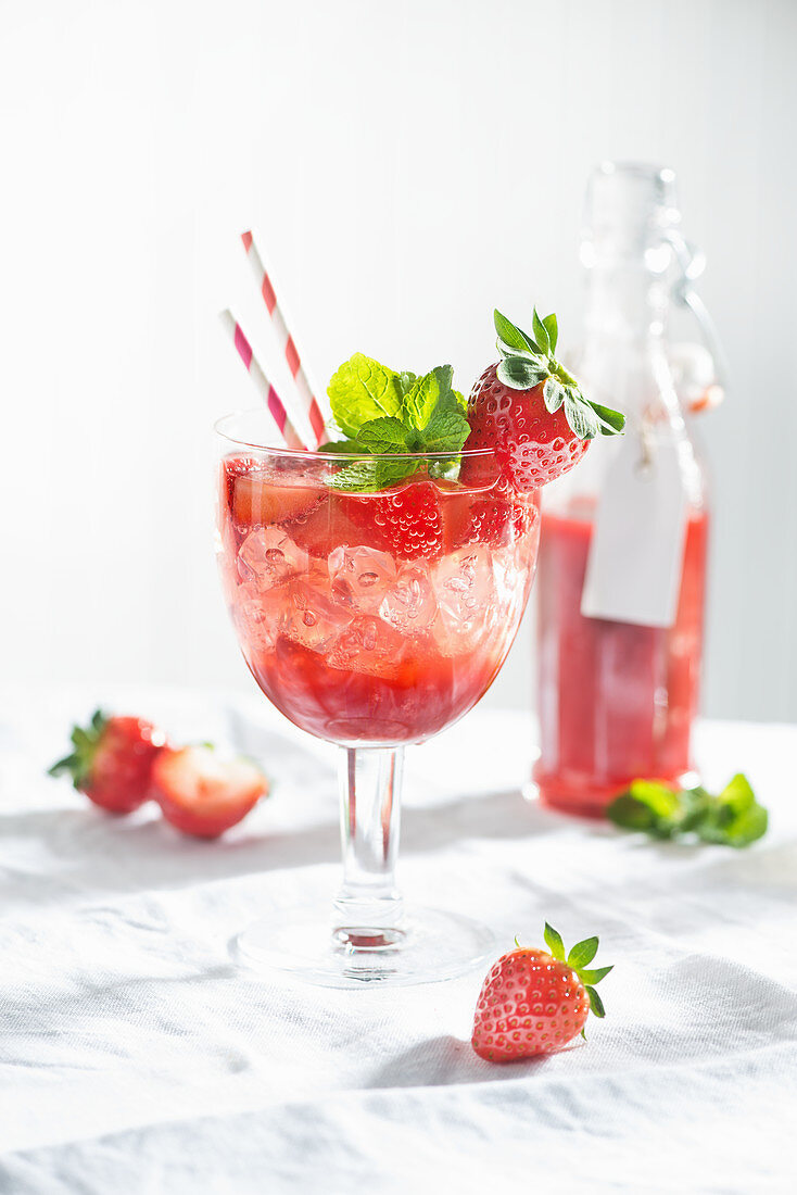 A summery strawberry spritzini made with strawberry purée, vodka and mint