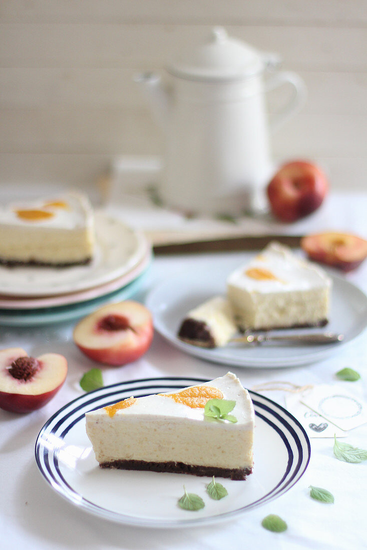 Three slices of cheesecake with peaches