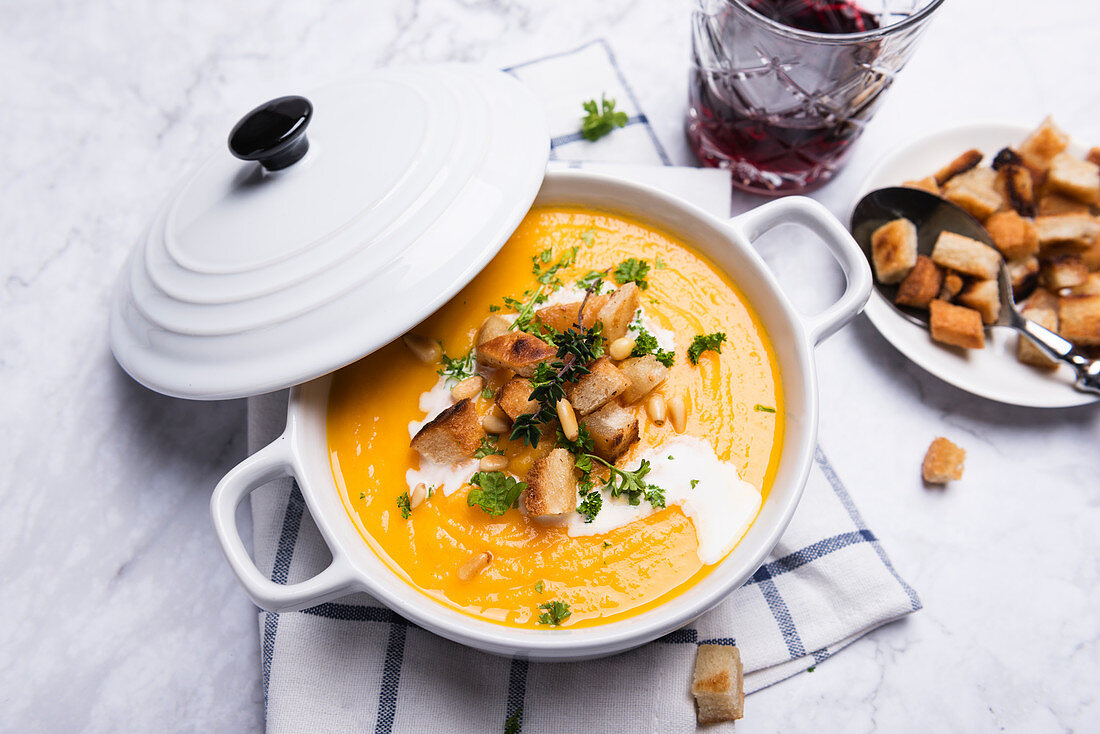 Karotten-Pastinaken-Suppe mit Croûtons, Pinienkernen und Kräutern