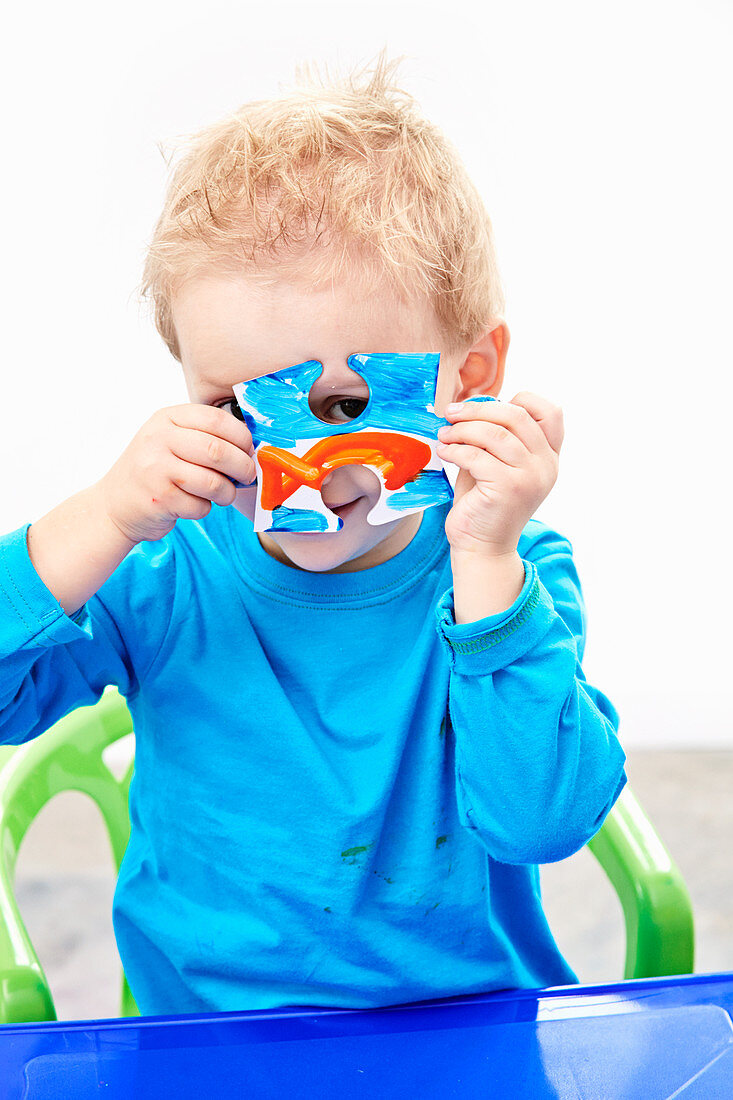 Little boy with hand-painted jigsaw