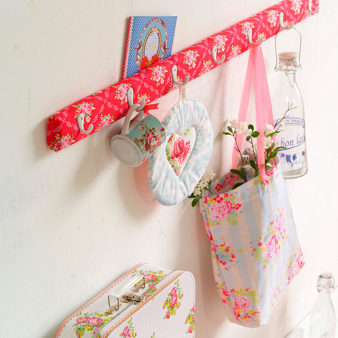 Row of hooks upholstered in floral fabric