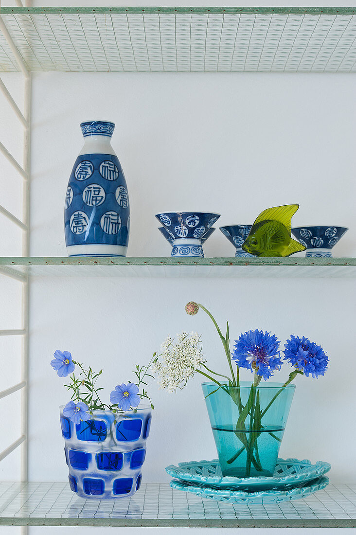 Chinese rice wine decanter and cups and flowers in drinking glasses