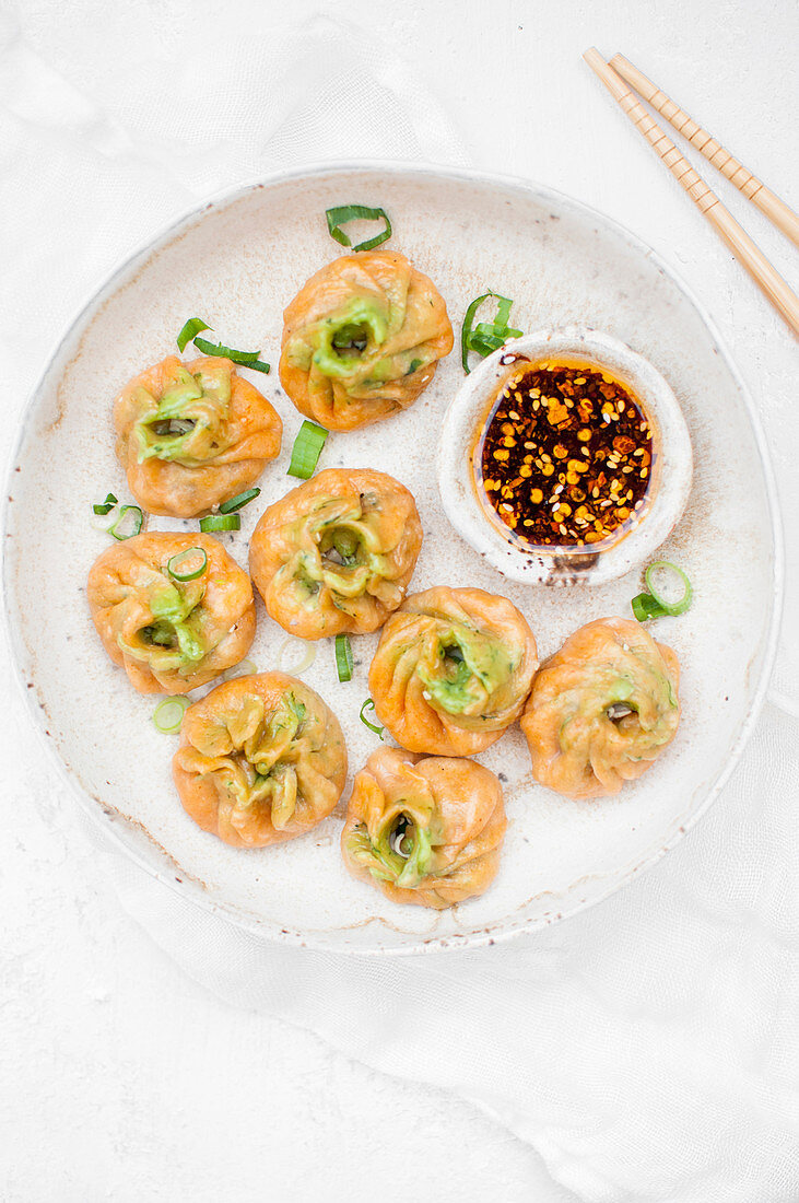 Pumpkin dumplings with vegan stuffing served with chilli oil