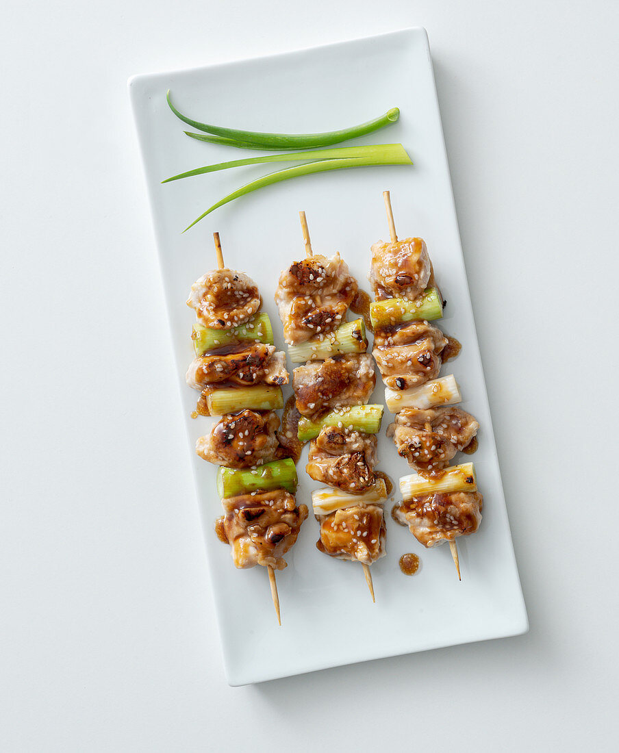 Yakitori with spring onions and a soy and honey sauce