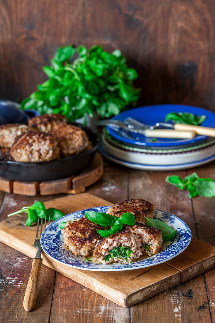 Minced meat cakes (balls) with herbs butter filling