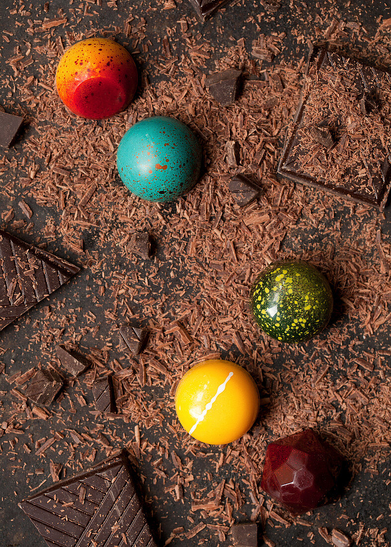Colourful pretty chocolates on grated chocolate