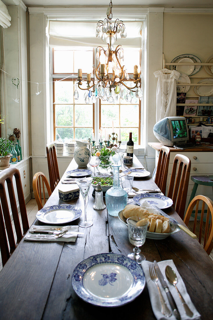 Set table and chandelier in country-house-style dining room