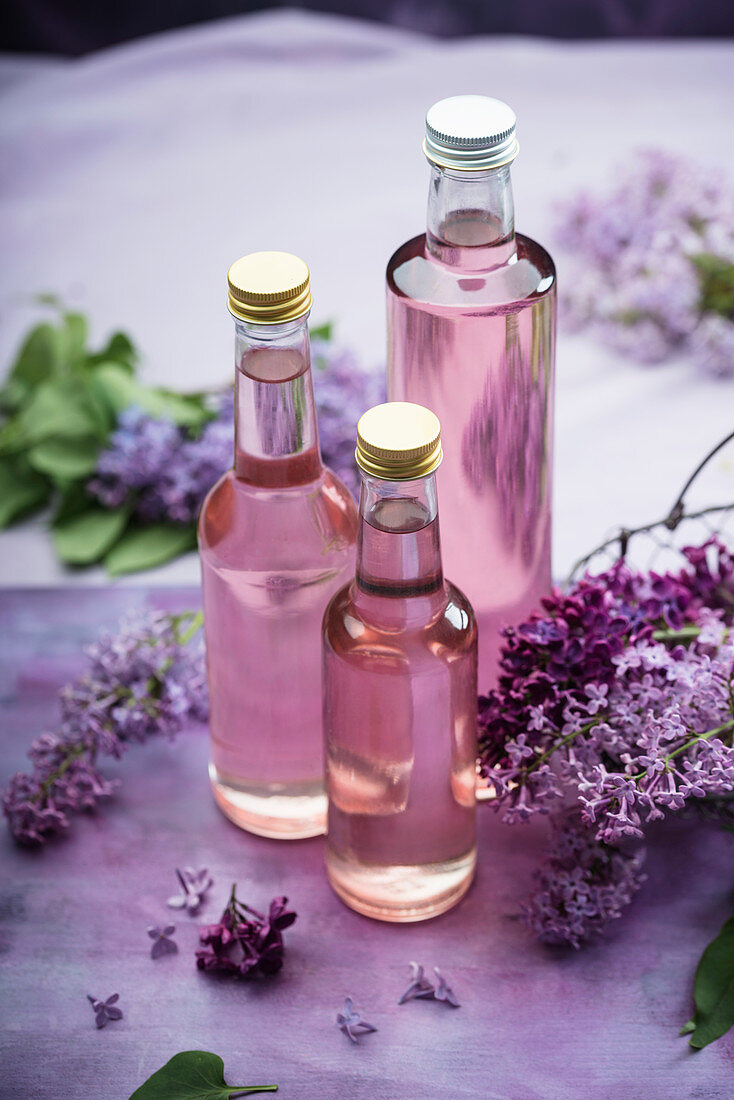 Homemade lilac syrup in bottles
