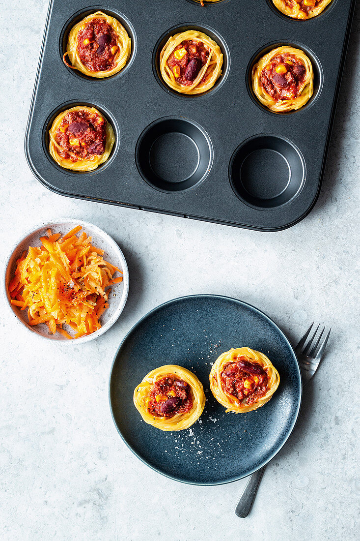 Pasta nests with raw apples and carrots