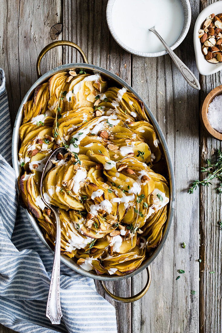 Smoked paprika roasted hasselback potato gratin - complete with a garlic yogurt drizzle