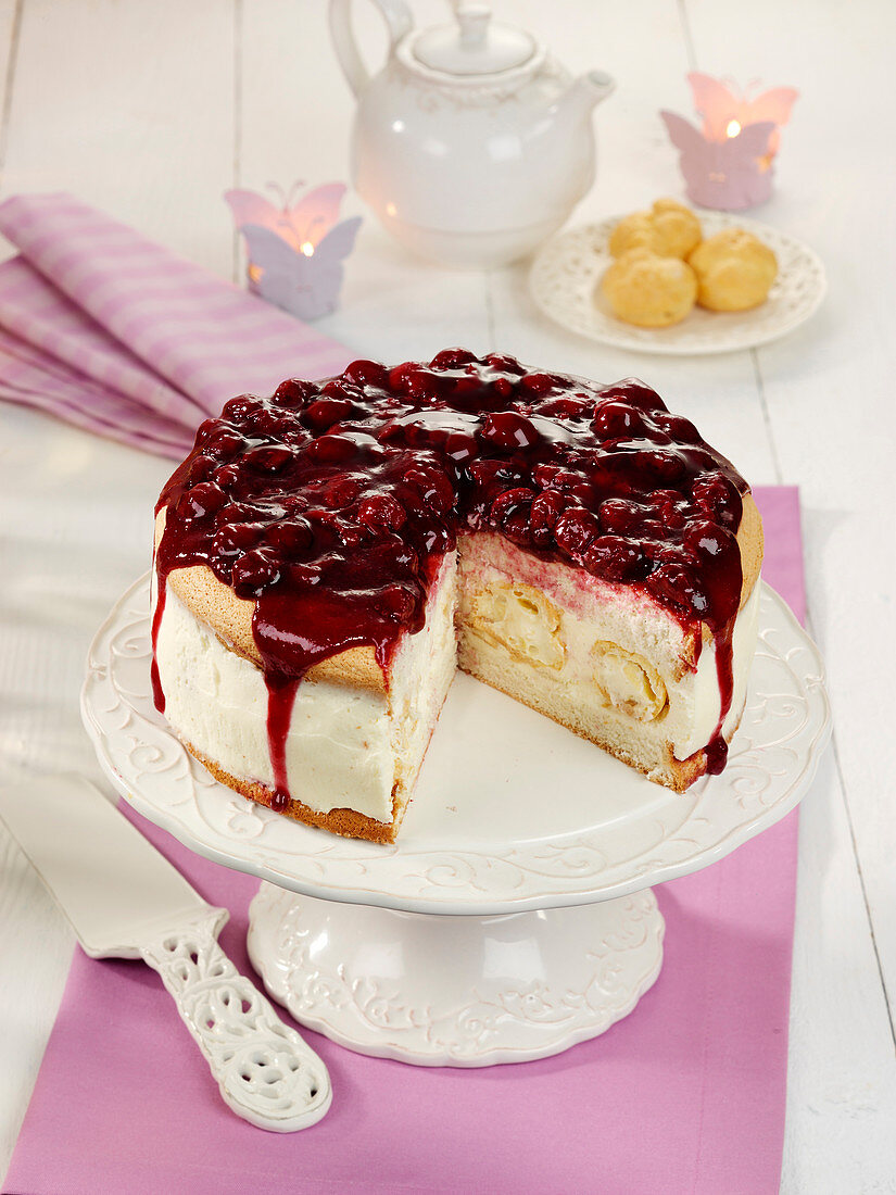 A profiterole cake with a cherry topping