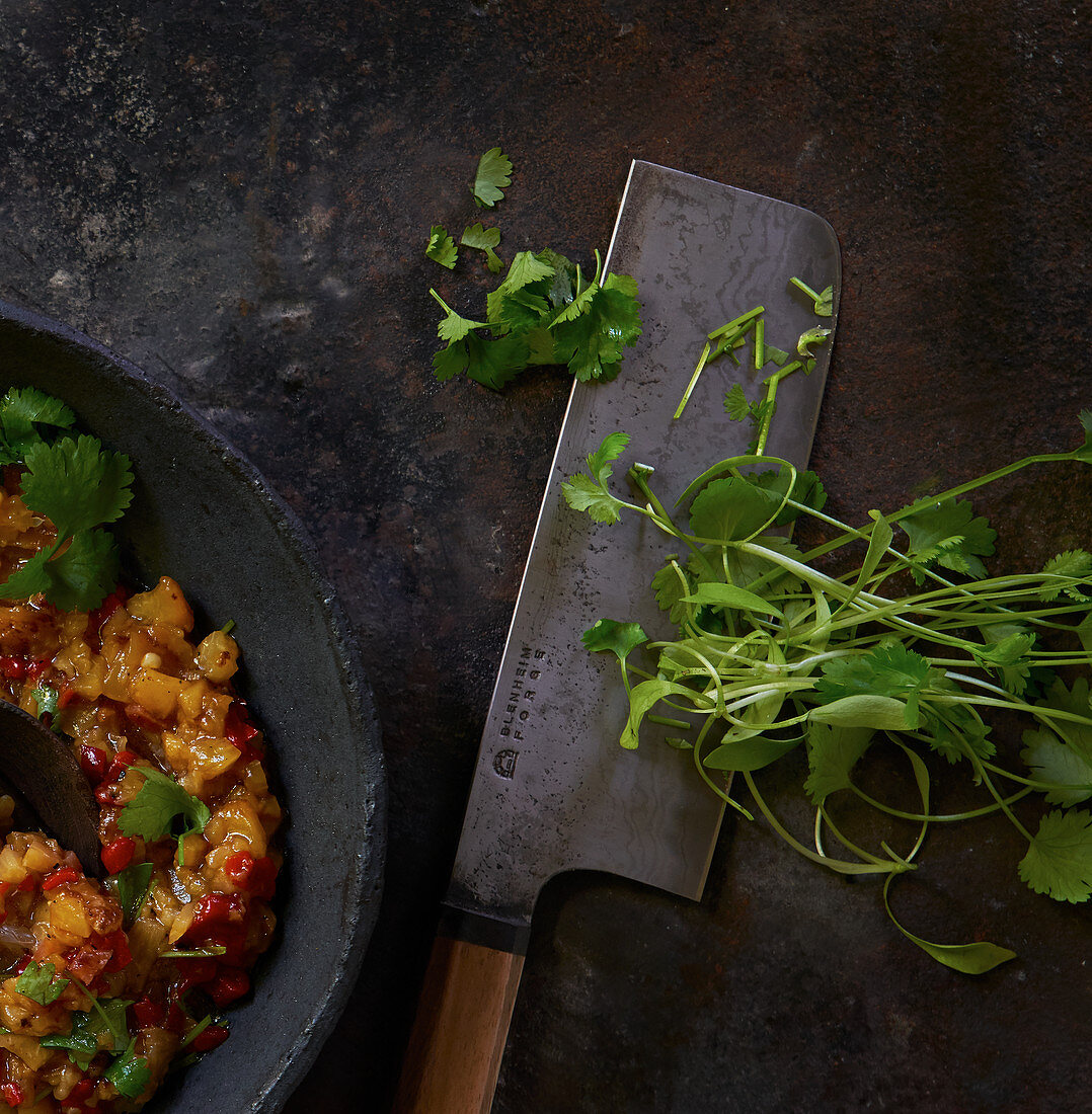 Charred peach and chilli sauce, a meat cleaver and coriander