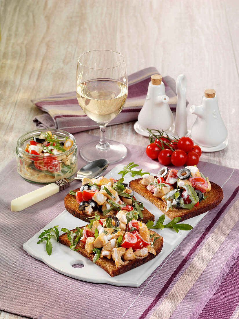 Chicken salad with olives on crispy bread