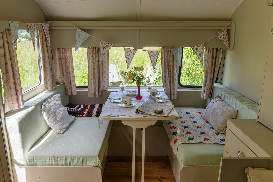 Bunting and set table in vintage-style caravan