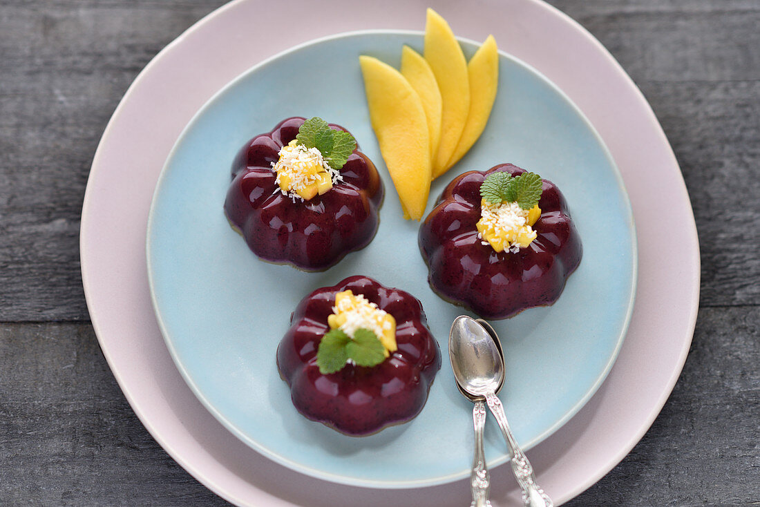 Vegan blueberry and coconut panna cotta with mango and coconut