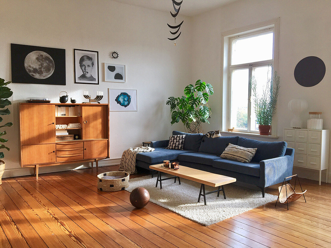 Sunny living room in mid-century style with wooden floor