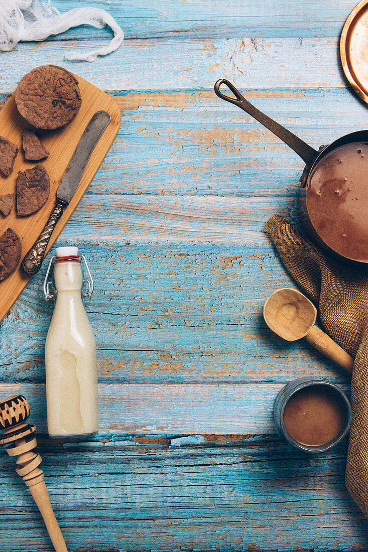 Chunks of chocolate and bottle of milk, utensils for preparing traditional Mexican hot chocolate